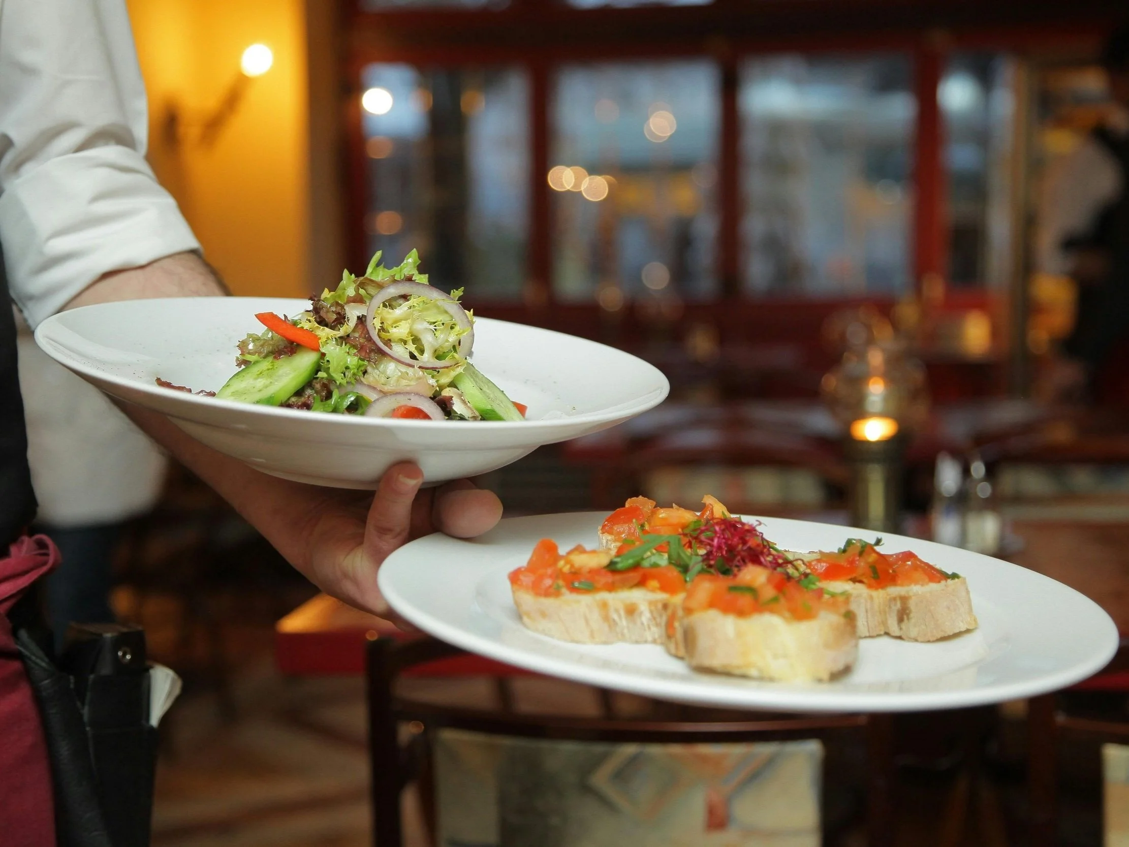 Chefs plating food in a professional kitchen